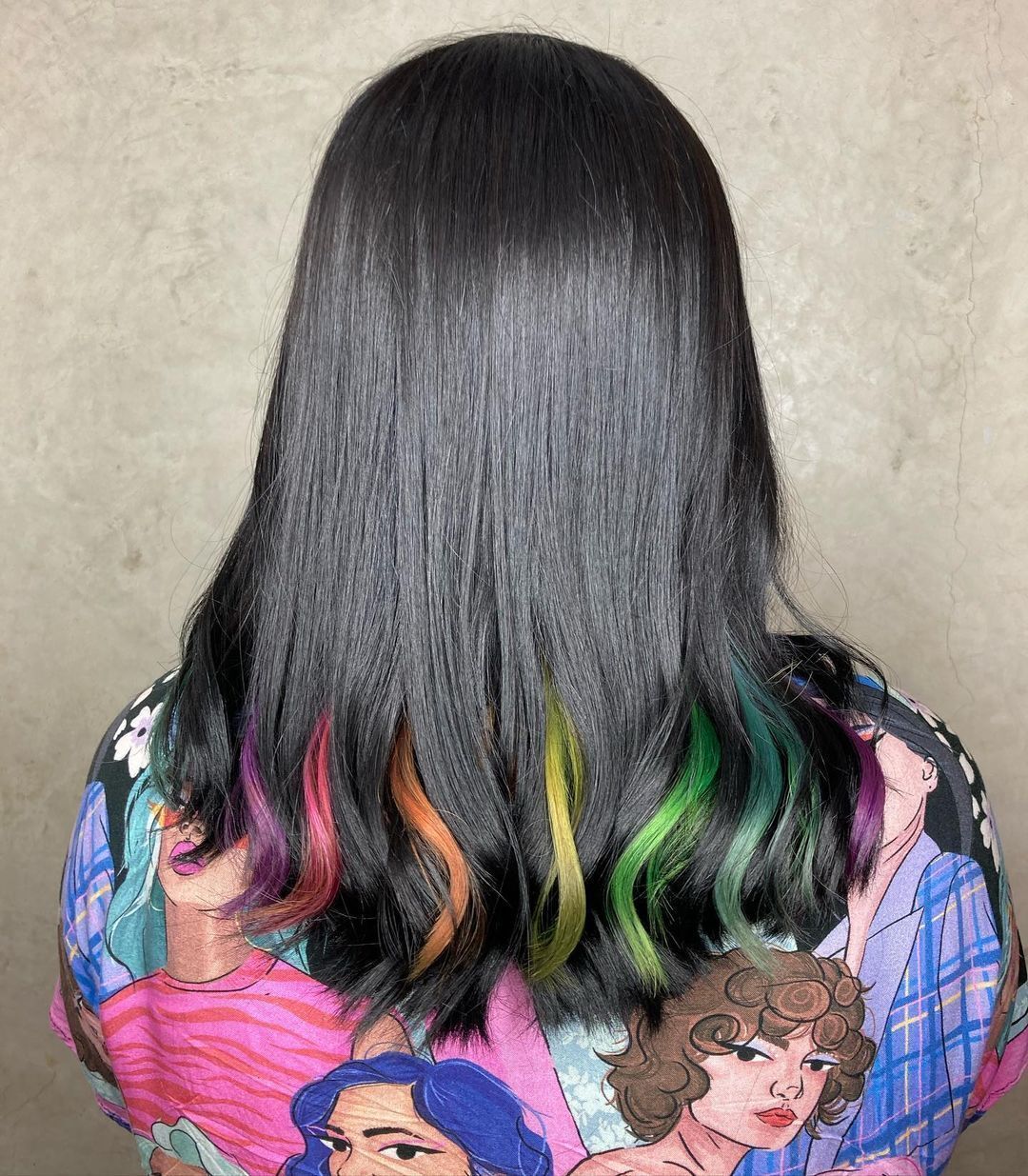 Back view of a girl with black hair and rainbow highlights