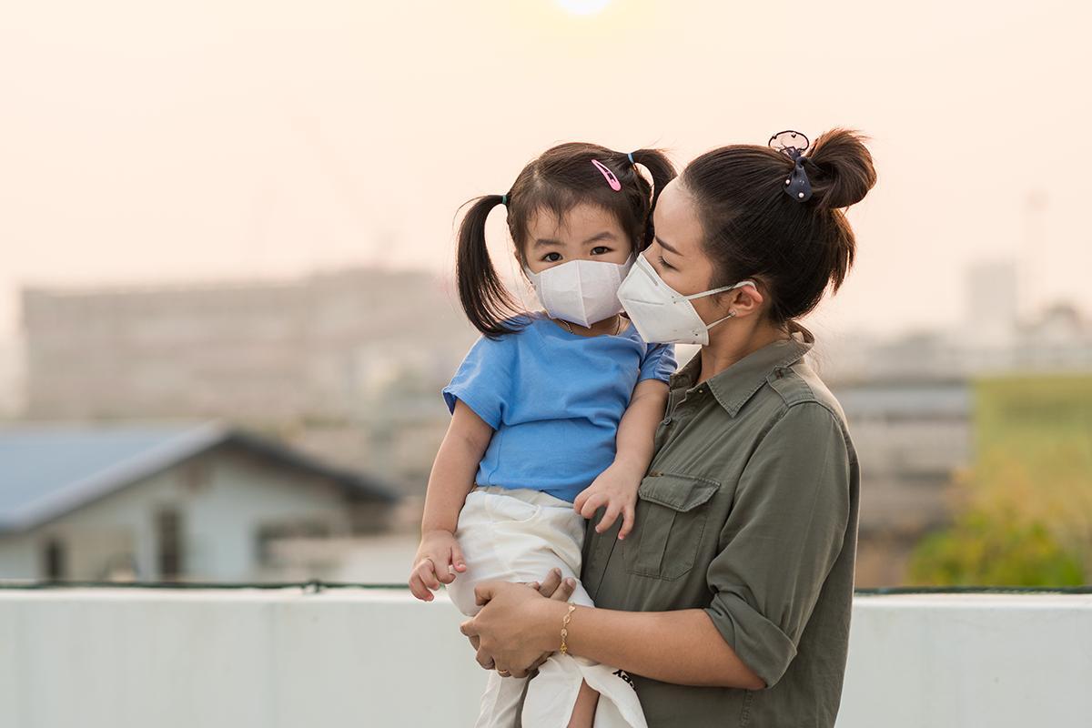 Asian mom and daughter wearing face masks