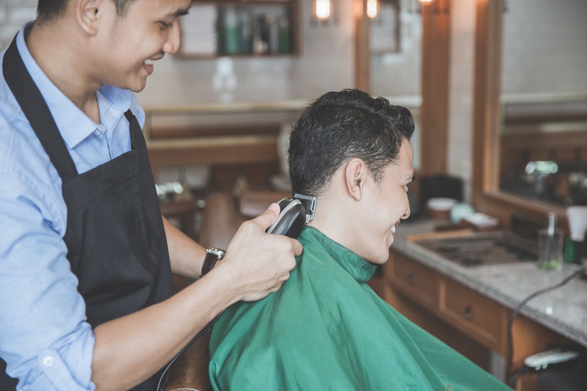 Asian man getting a haircut
