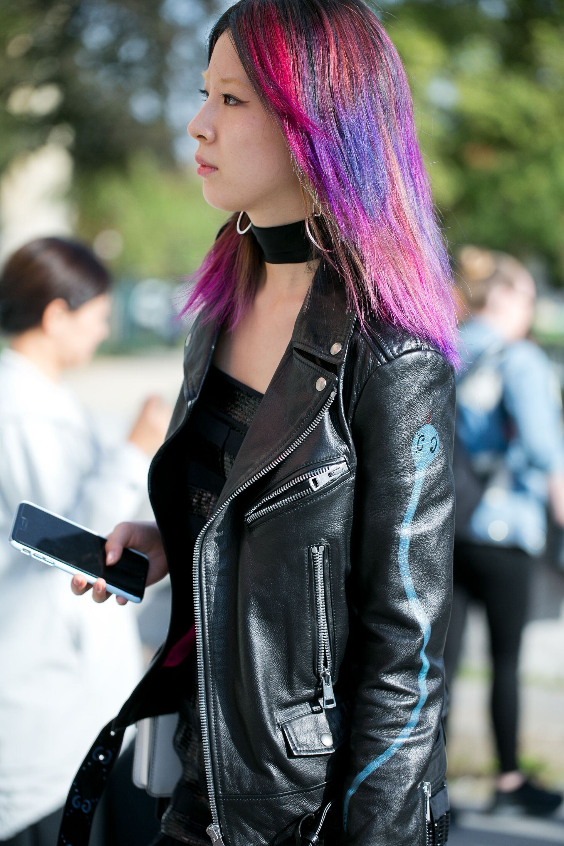 Irene Kim with rainbow hair, wearing an all leather outfit.