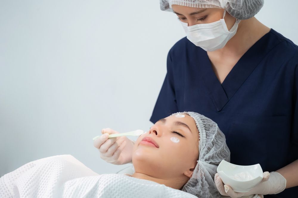 Woman getting a facial treatment at a clinic.