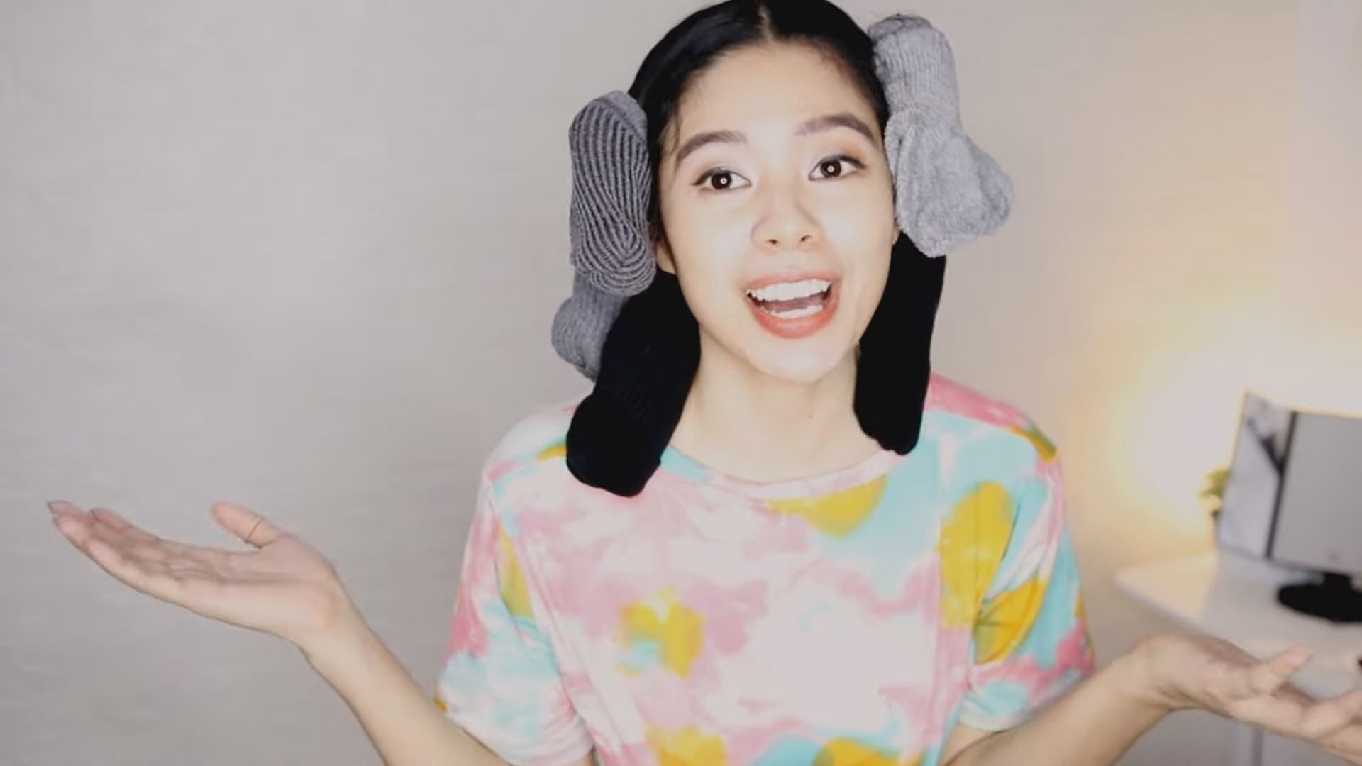 Woman wrapping her hair in sock buns.