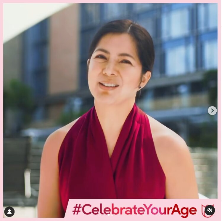 Alice Dixson in a red halter top outdoors