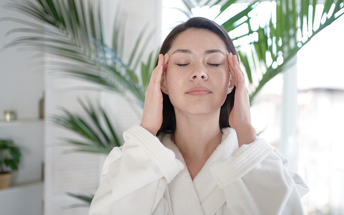 Woman applying moisturizer