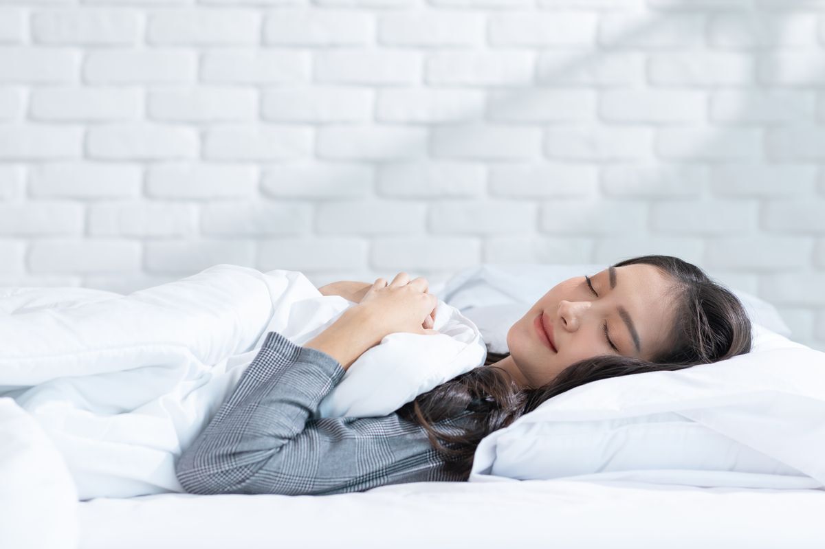 Woman lying on a bed comfortably. 