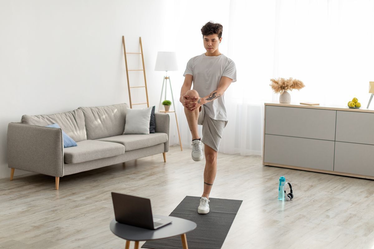 Man doing stretching exercises at home 