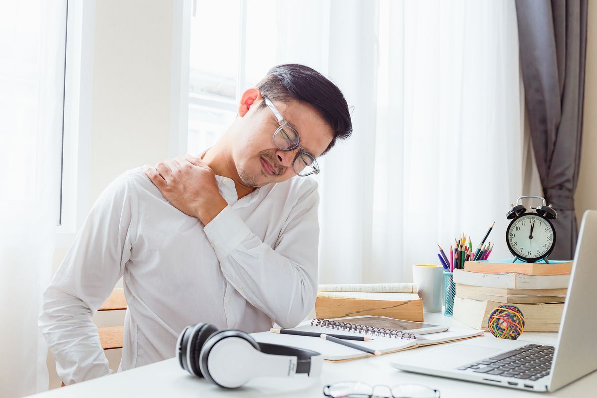Man with aching neck while working