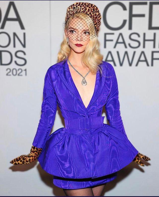 Woman in a purple dress and leopard print hat and gloves