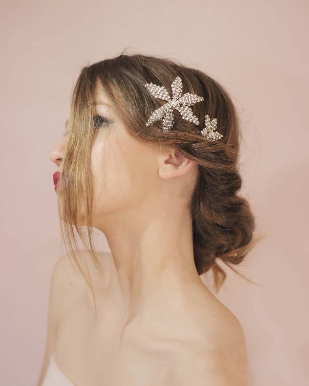 Woman with twisted bun hairstyle and crystal comb.