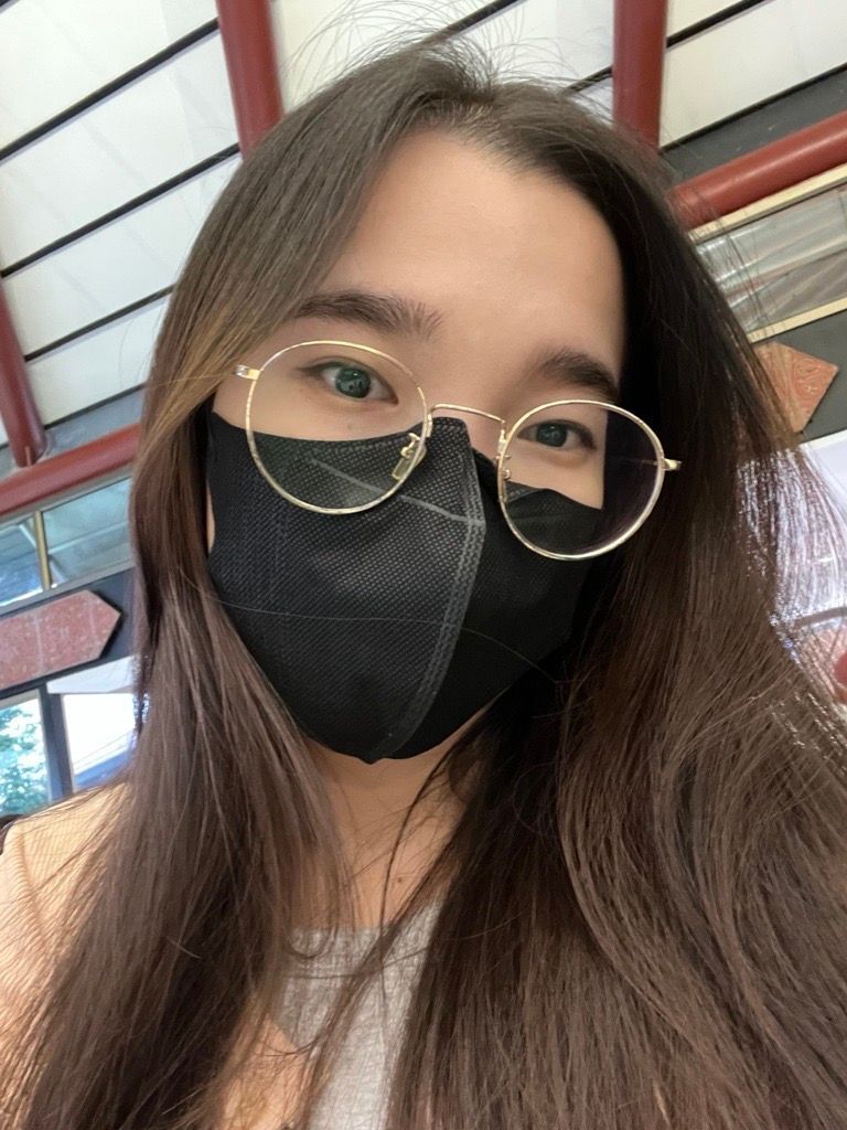 A selfie of woman wearing glasses and protective mask.