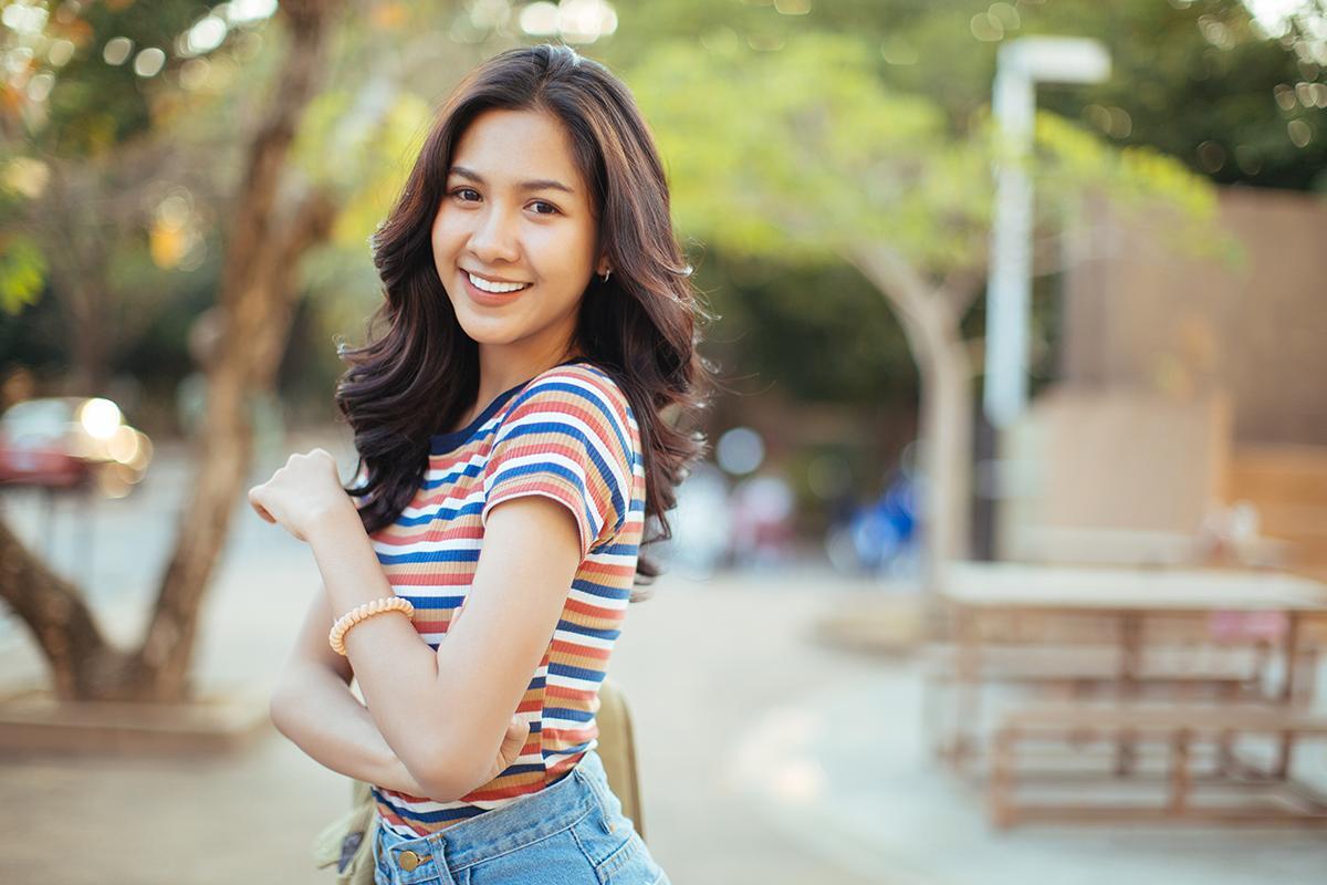 Beautiful Asian woman in striped shirt and jeans