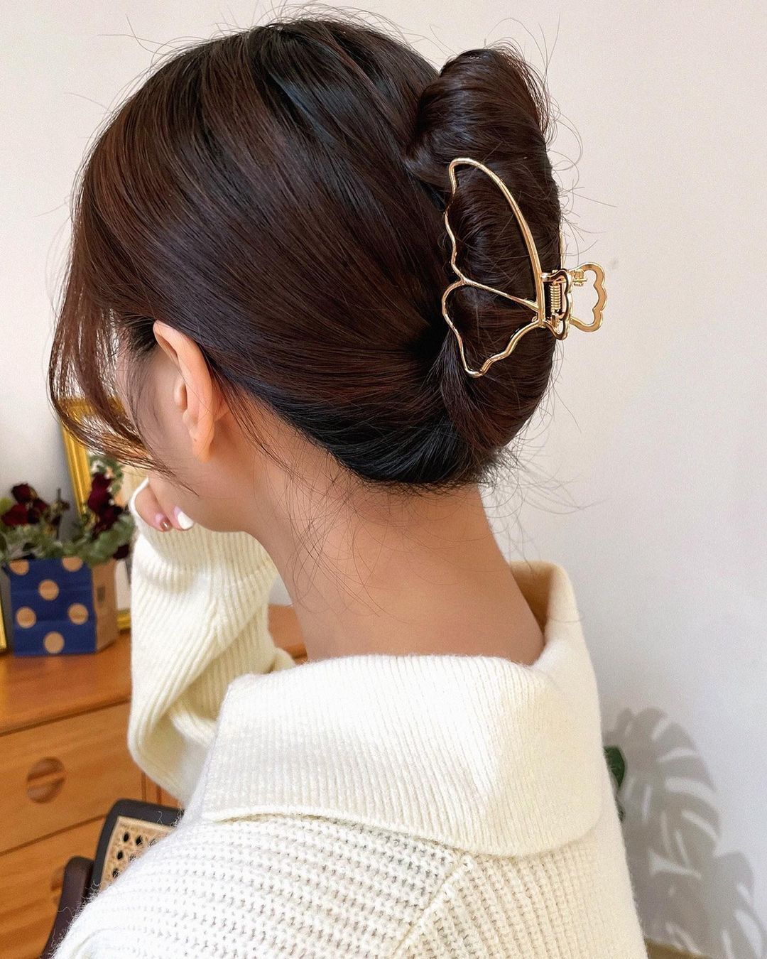 Woman with a French twist hair and butterfly hair clip.