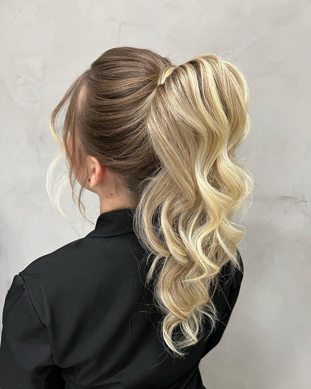 Woman with a blonde high ponytail.