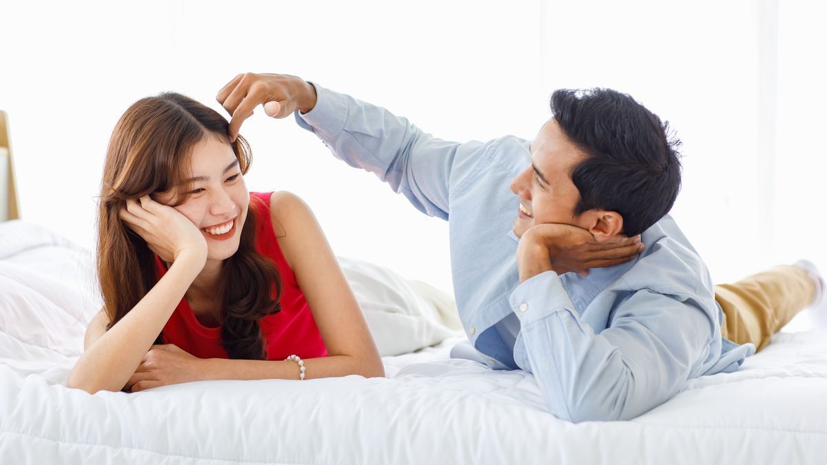 Man tucking girl’s hair