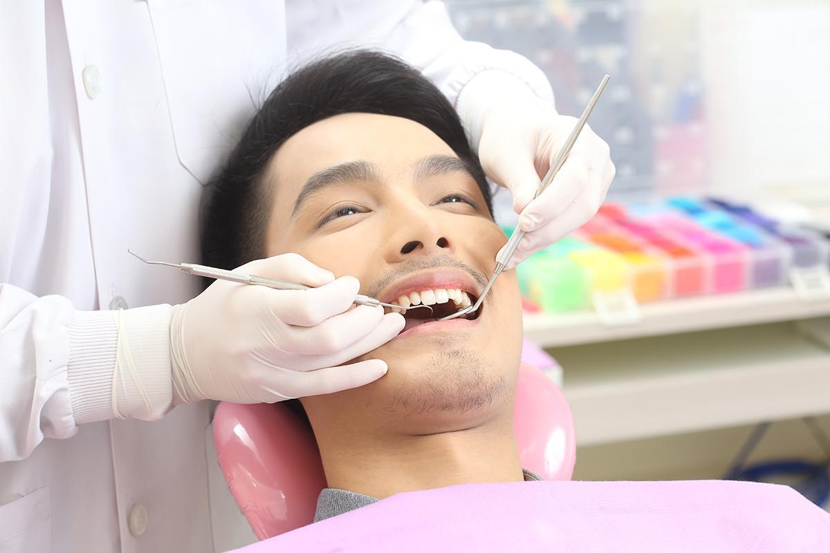 Asian man having his teeth checked at dentist’s