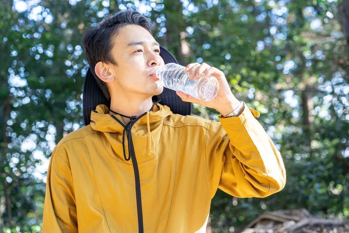 Asian man drinking water