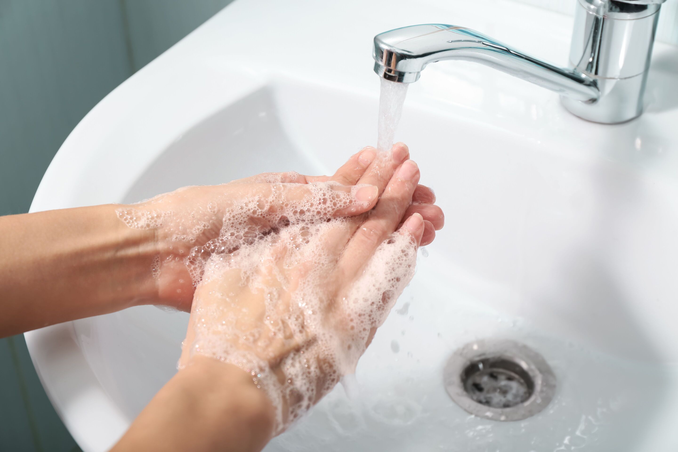 Woman washing hands in the sink