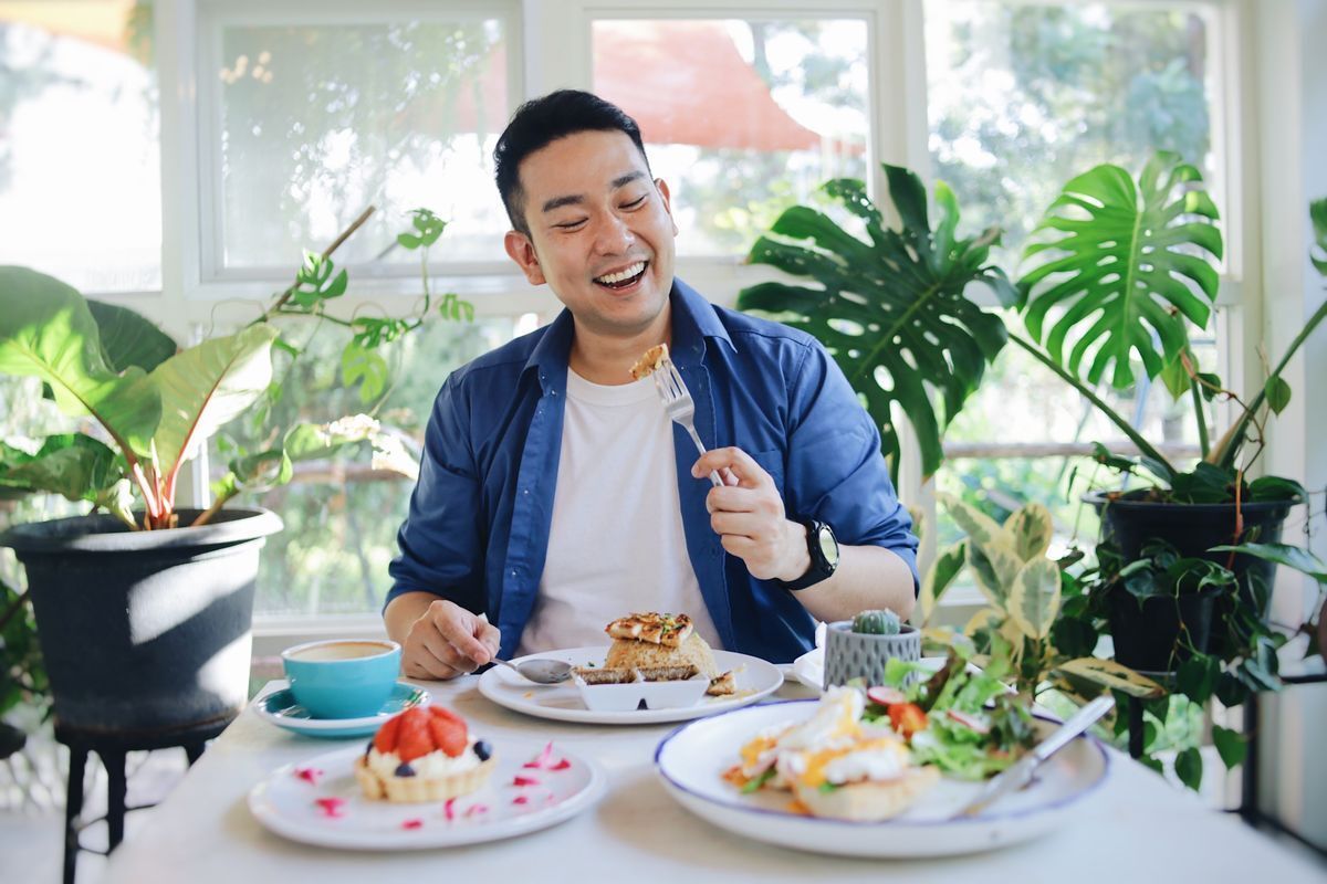 Man is ready to put food into his mouth.
