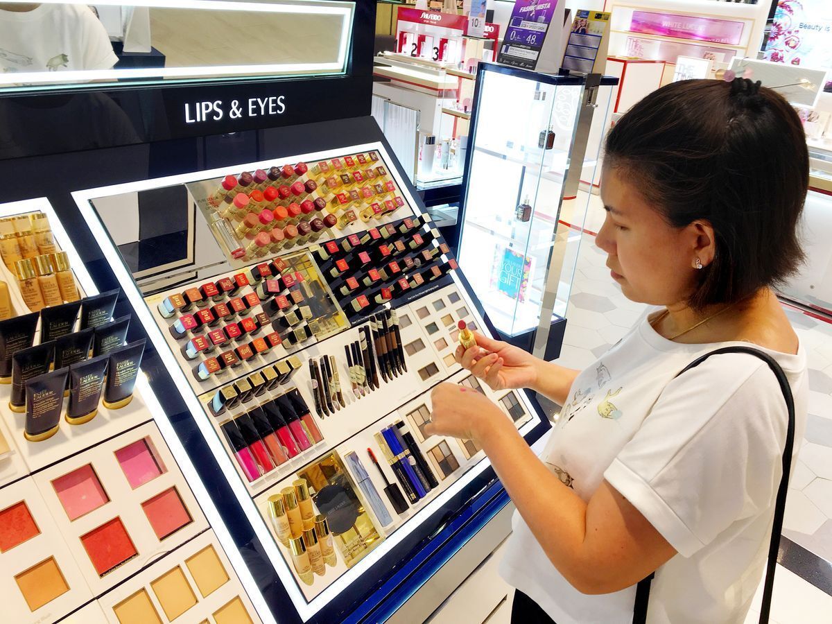 Asian woman testing products at a beauty counter