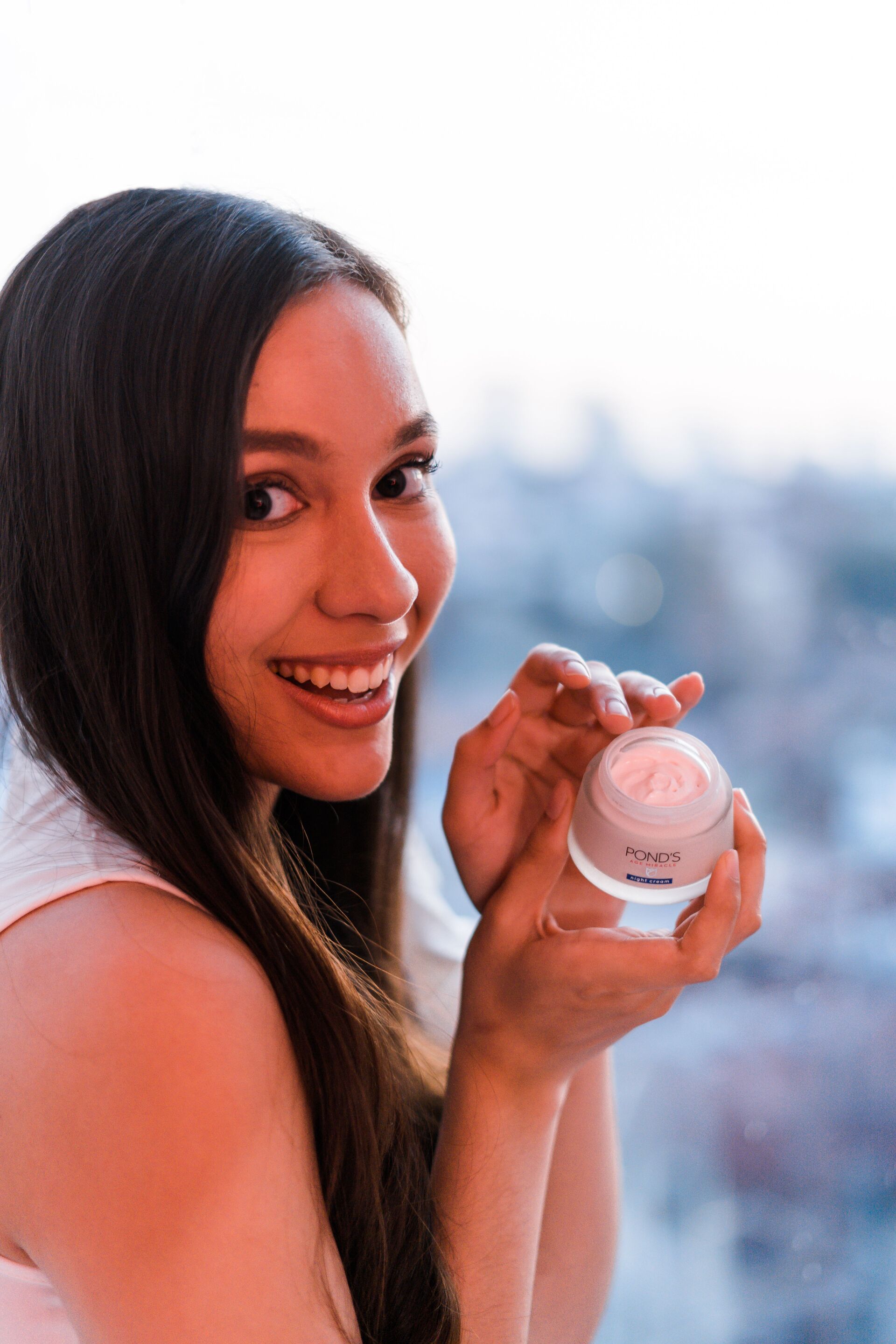smiling woman with night cream
