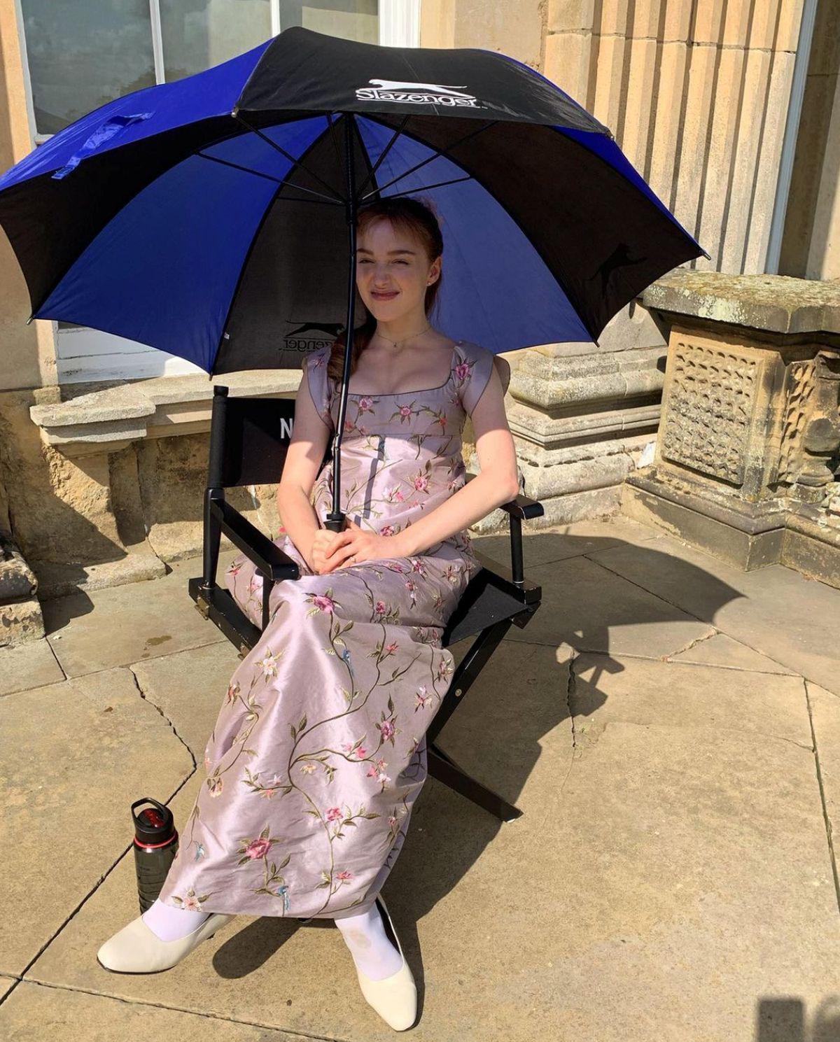 Woman covered by an umbrella under the sun