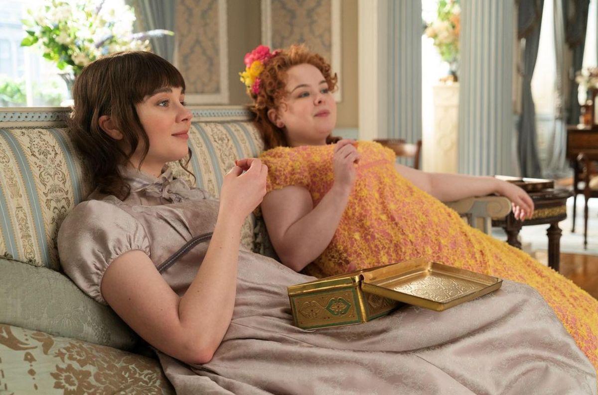 Two young women in empire waist dresses