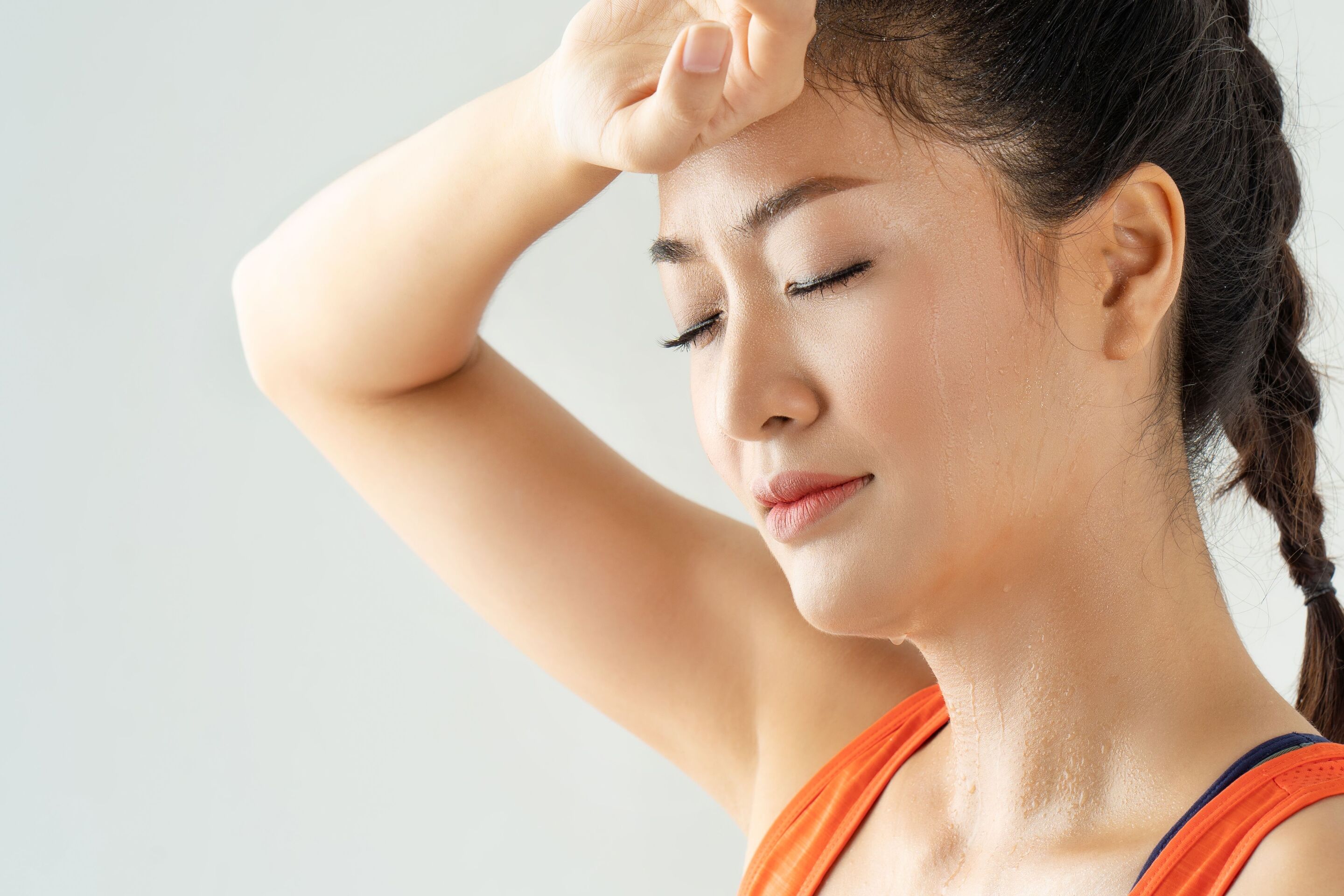 A woman wiping her sweat