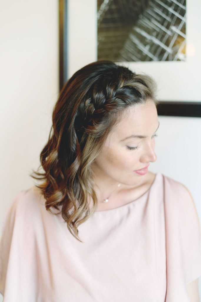 Woman with short hair and braided headband.