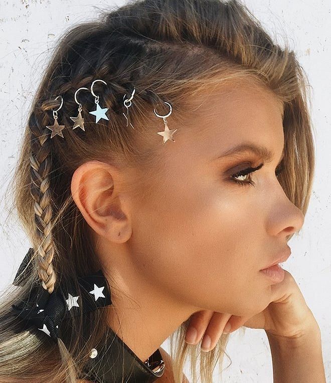 Woman with faux undercut and star hair rings.