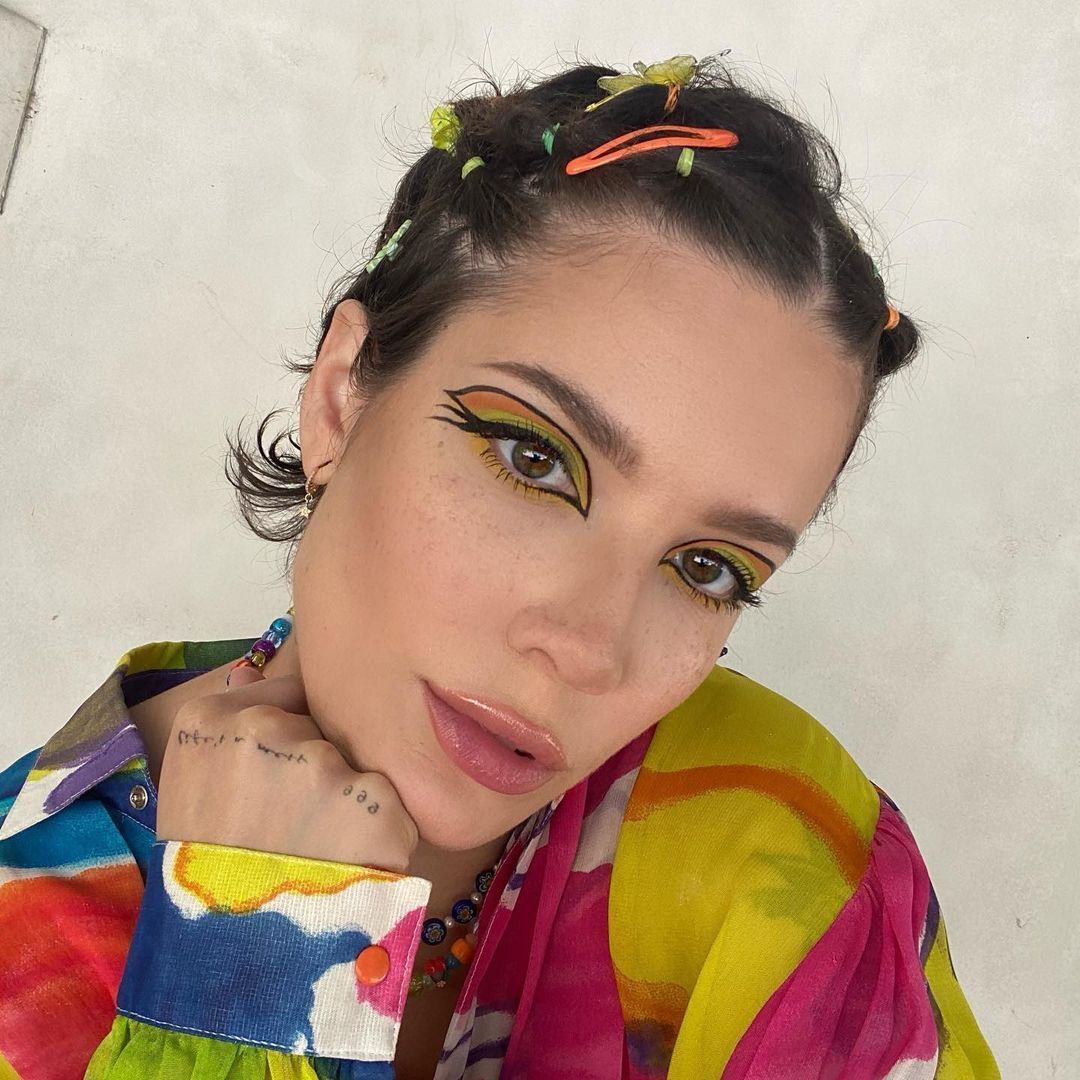 Halsey in a colorful top and hair styled with hair clip
