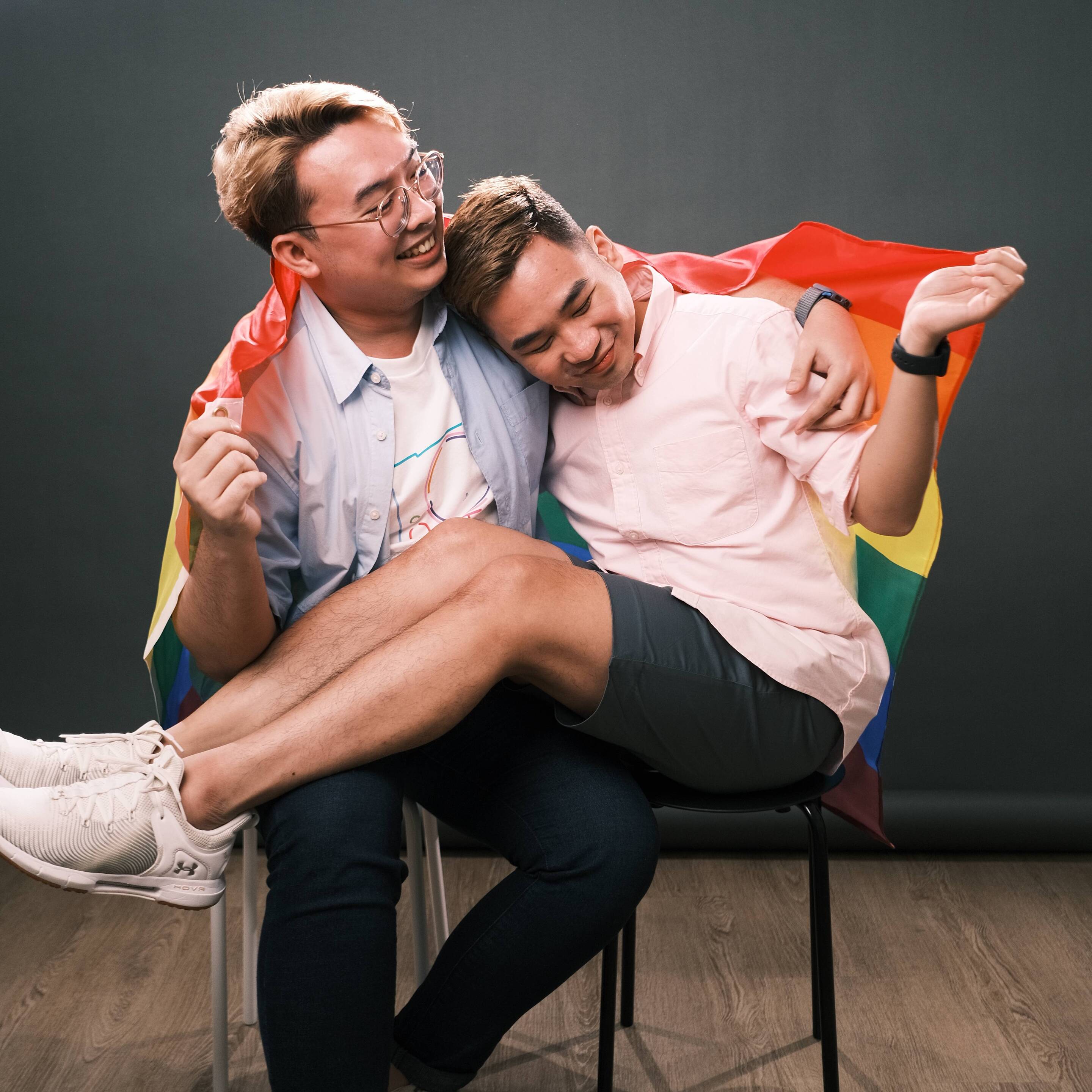 A couple holding the Pride flag.
