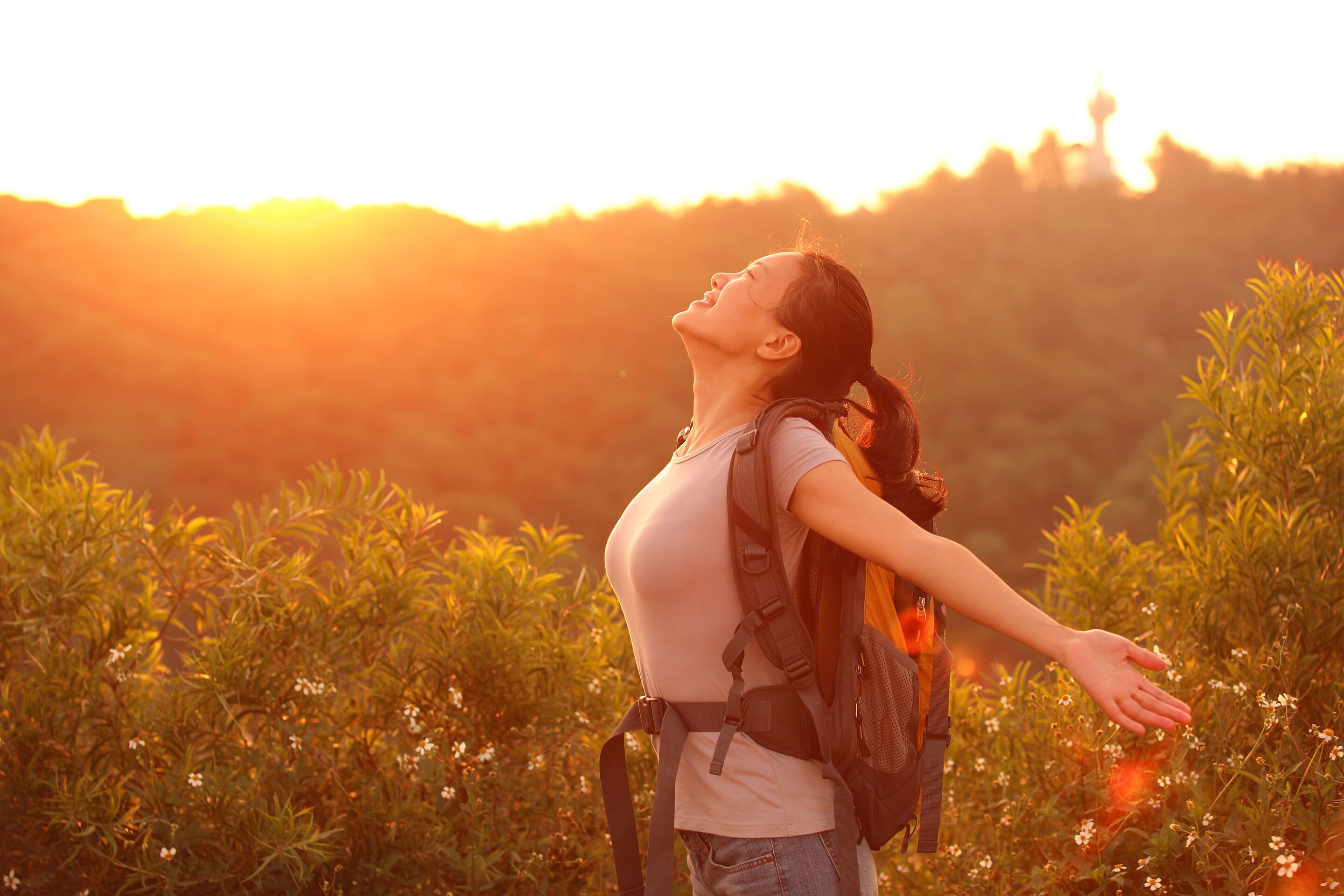 Thankful female hiker basking in the sunrise