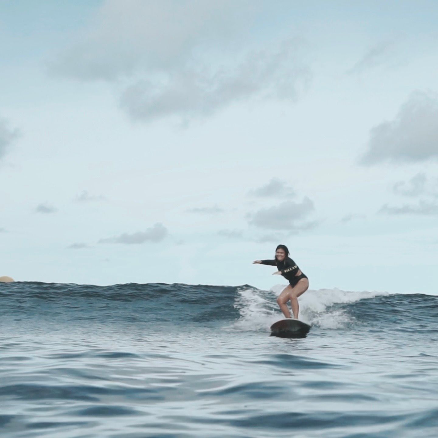 Asian woman surfing.