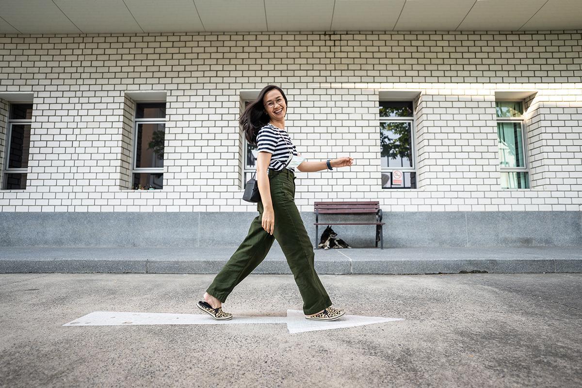 Happy Asian woman walking outdoors