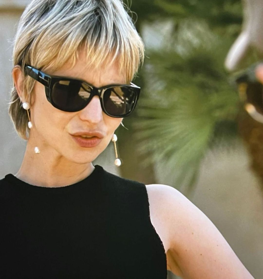 A portrait of Annabelle Dexter-Jones with short mullet hair as Naomi Pierce in Succession.