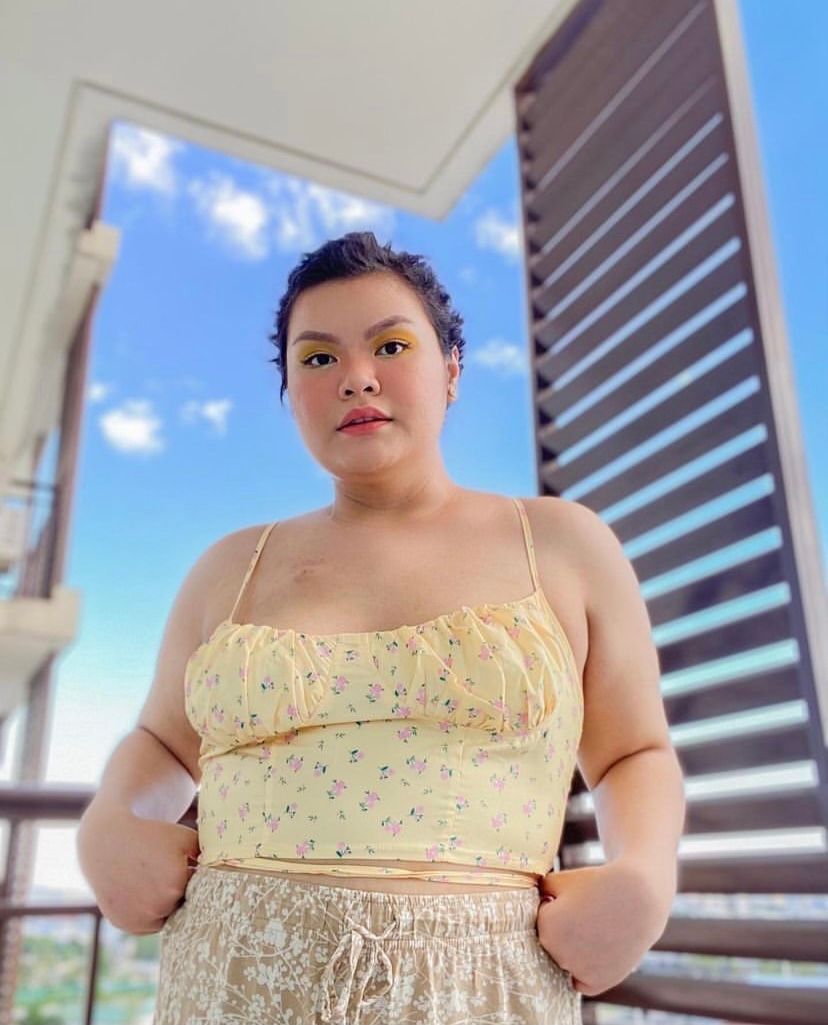 Confident plus size Asian woman with short hair