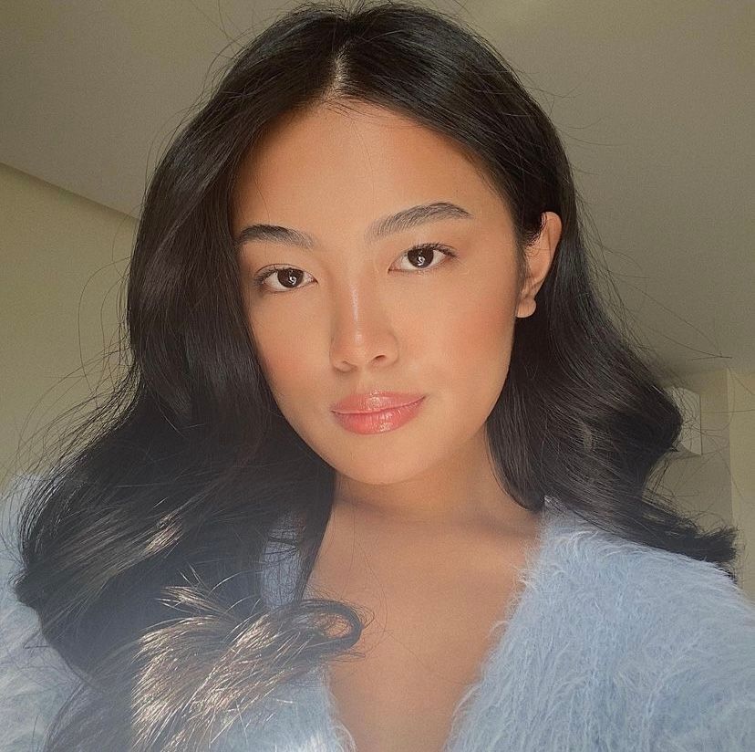 Closeup of a young Asian woman with long wavy hair