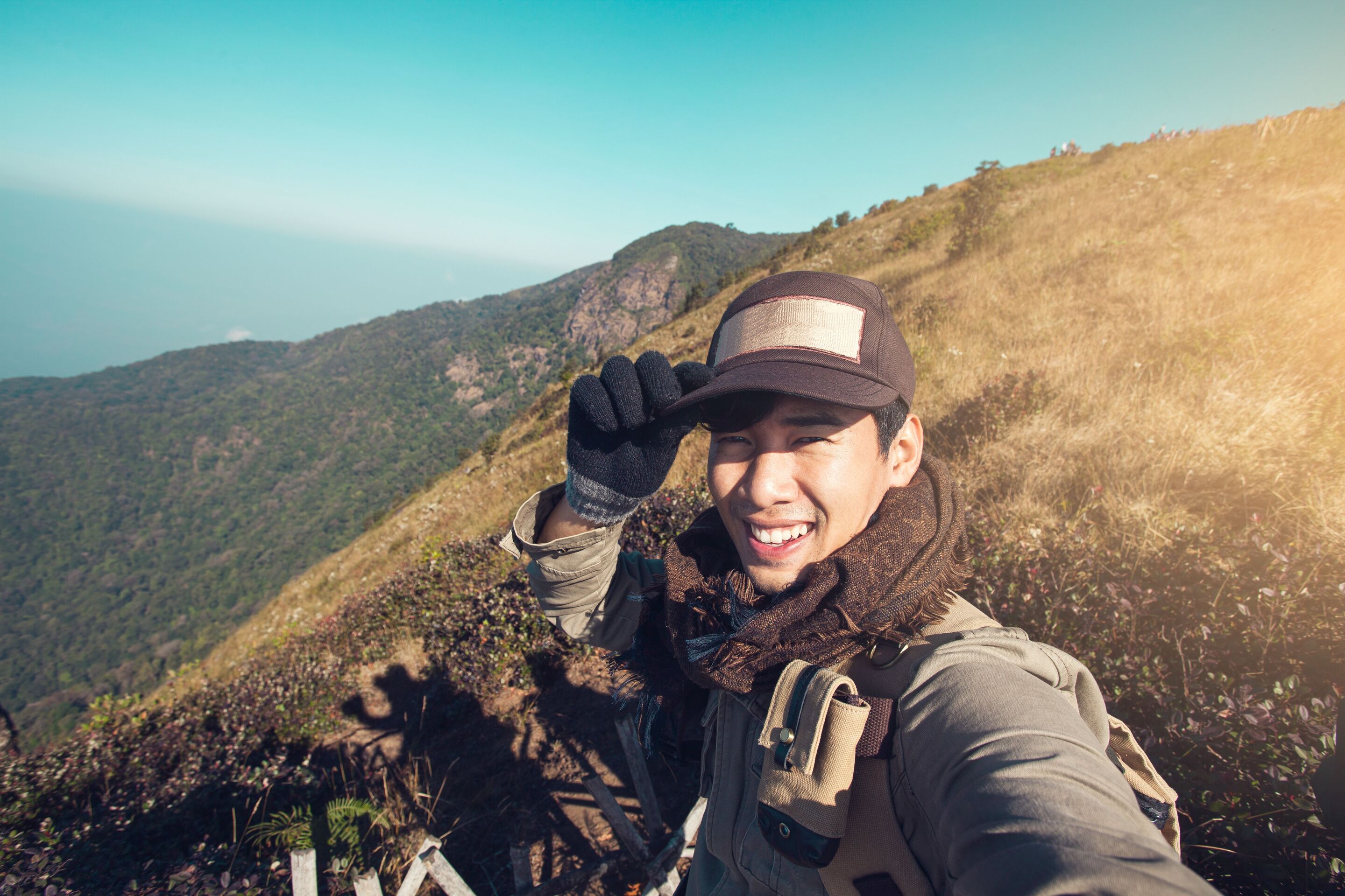 Young Asian millennial man smiling while travelling