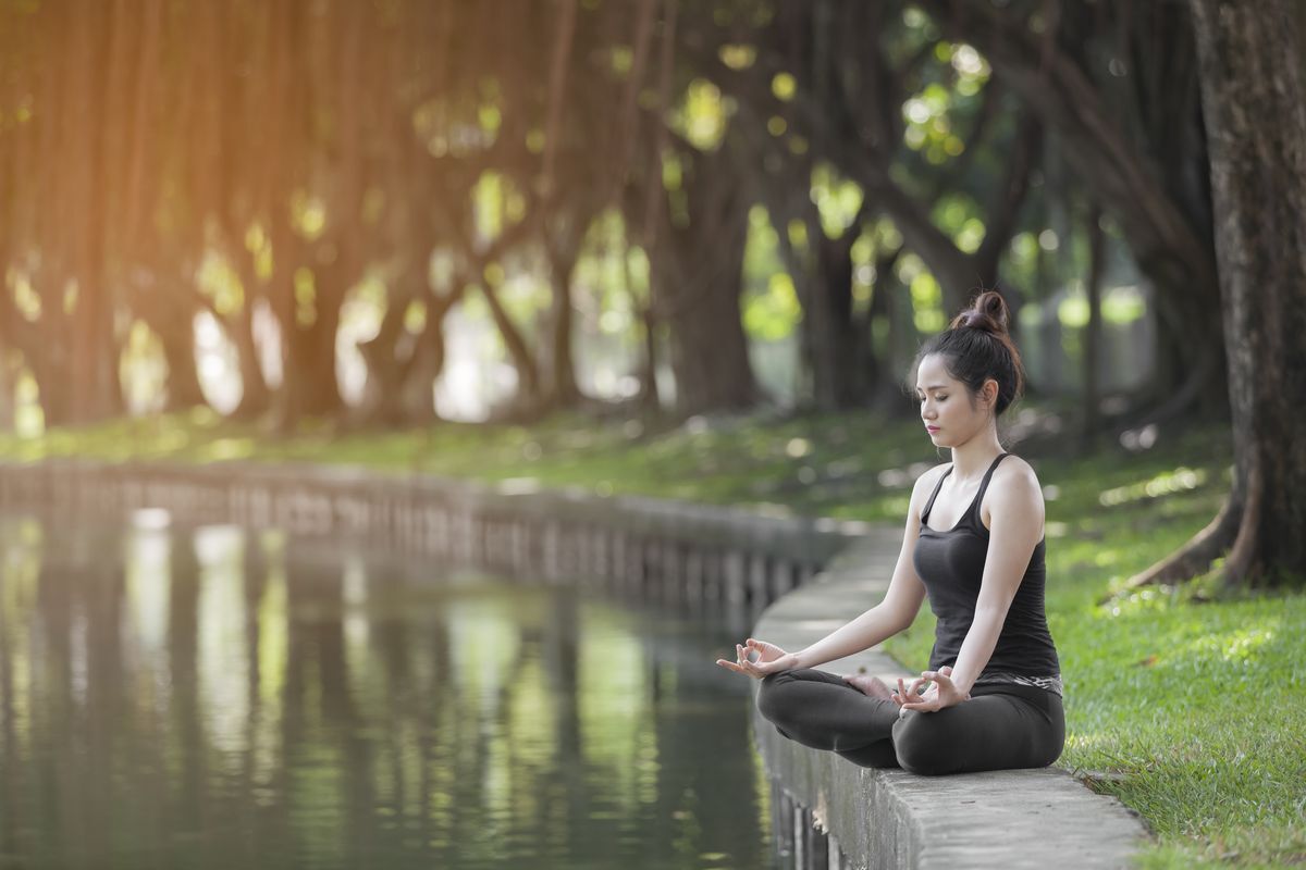 Asian woman meditation at park