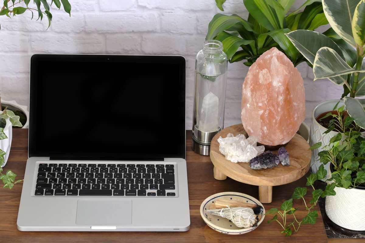Laptop and salt lamp beside it 