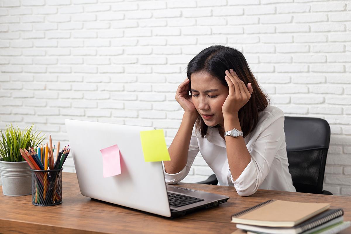 Asian businesswoman stressed out at the office