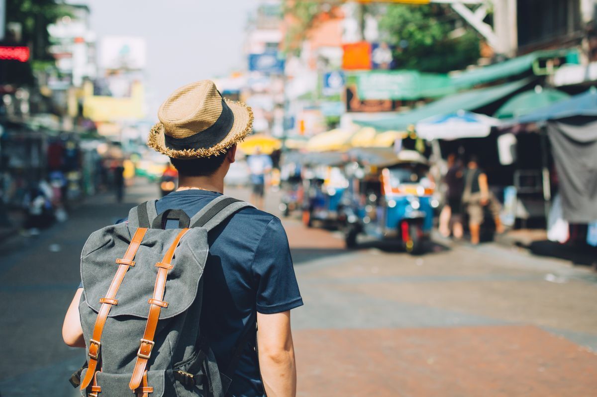 Man with backpack on busy road