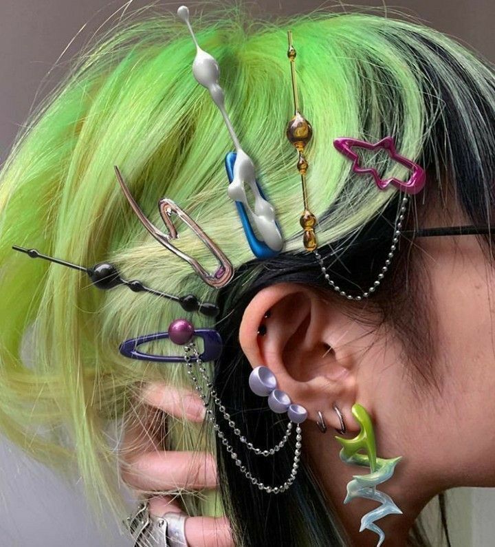 A portrait of woman with mullet hair and stacks of hair clips.