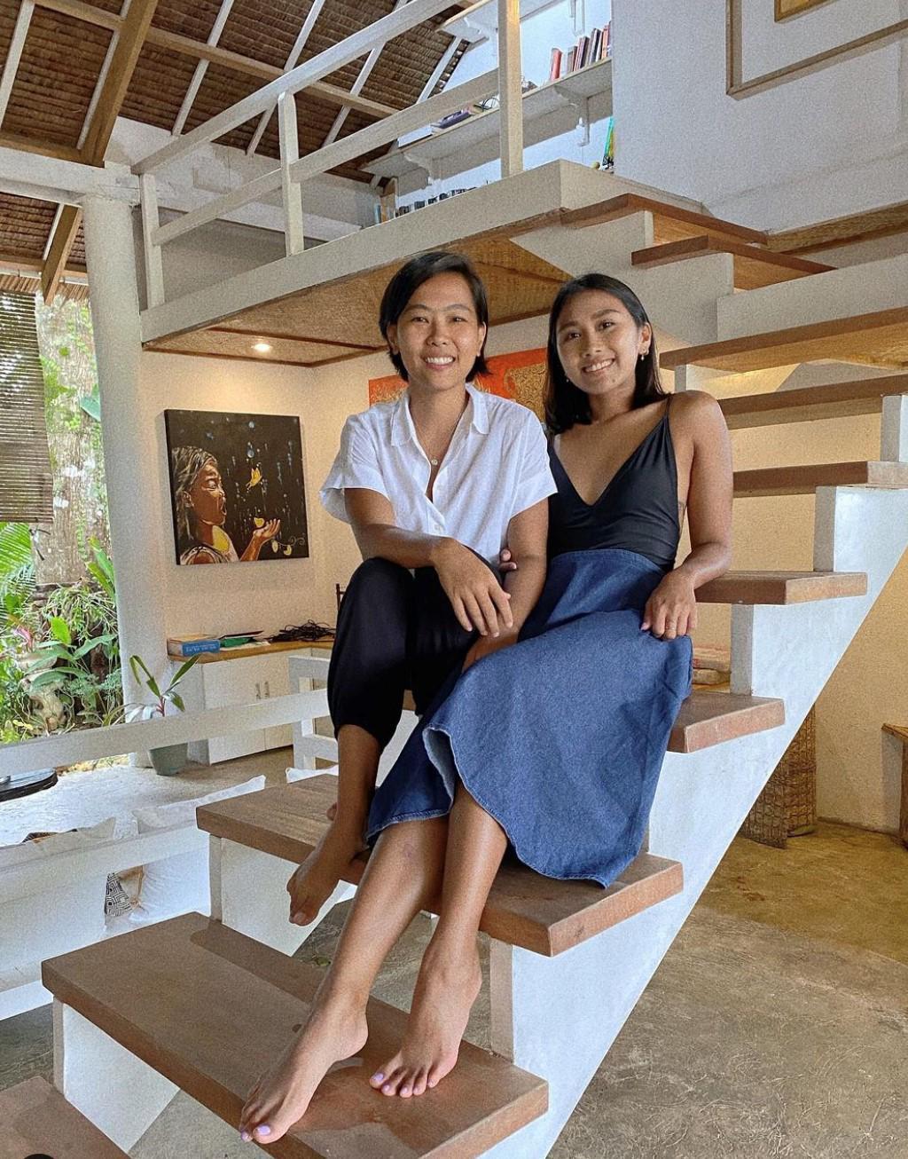 Lesbian couple posing on a staircase