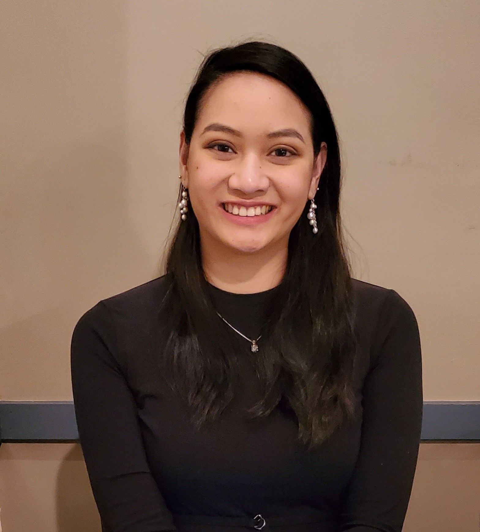 Asian woman in a black top smiling
