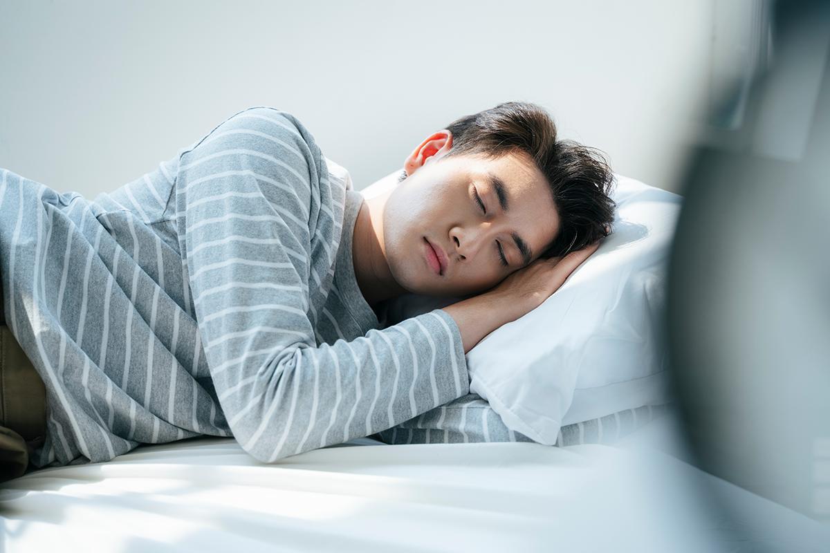 A man sleeping with a pillow