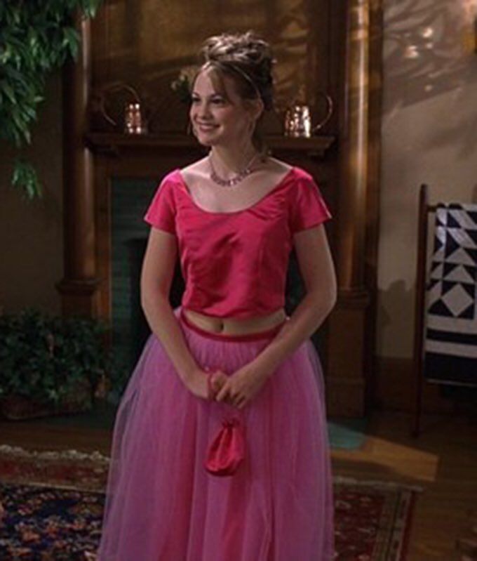 Smiling teenage girl in a pink prom dress. 