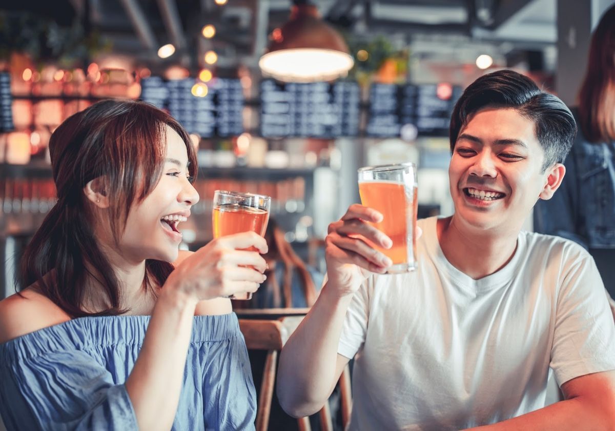 Asian couple having a beer together