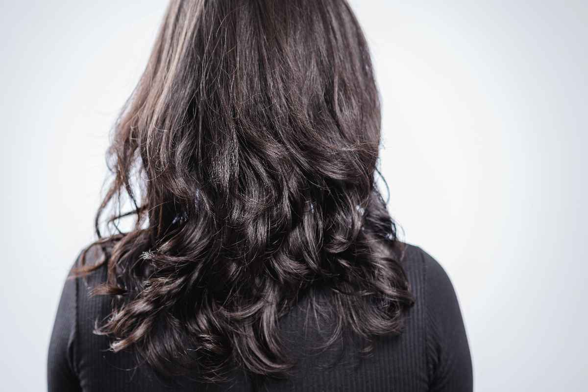 Woman with long dark, dry hair.