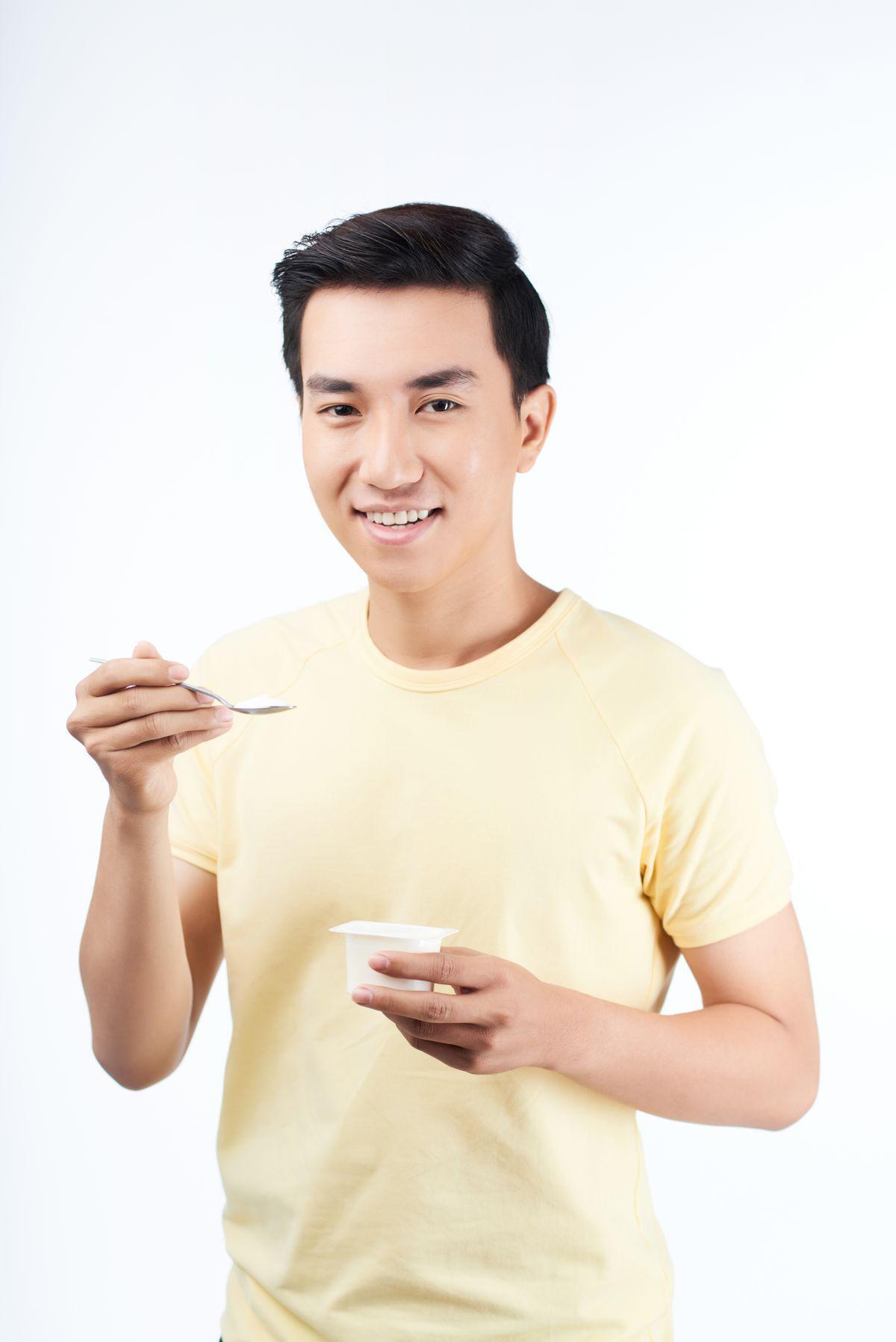 Asian man eating yellow